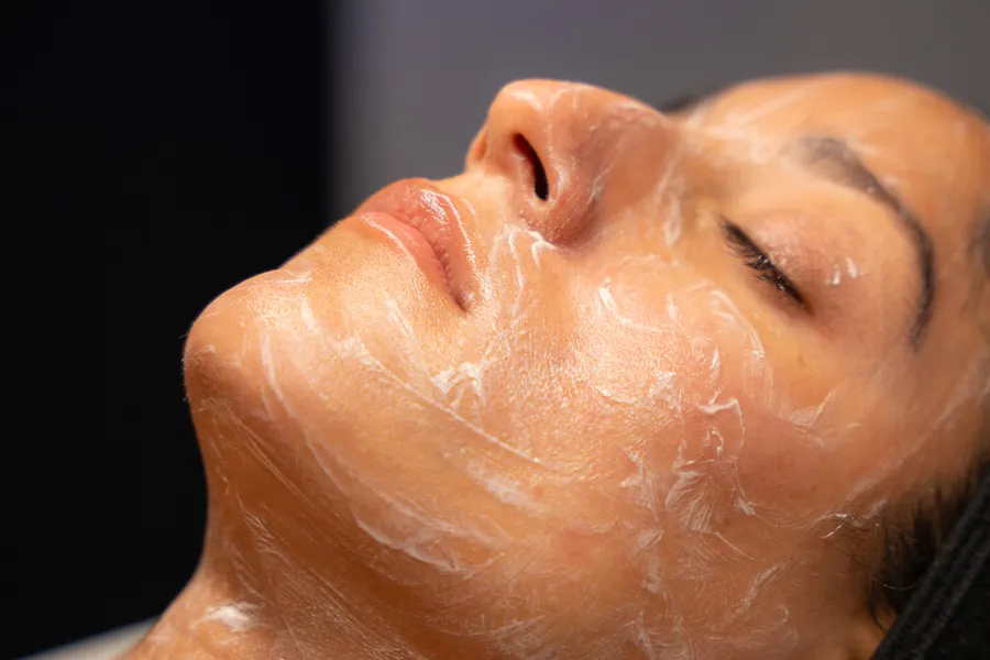 A guest resting with serum on her skin during a HydraFacial