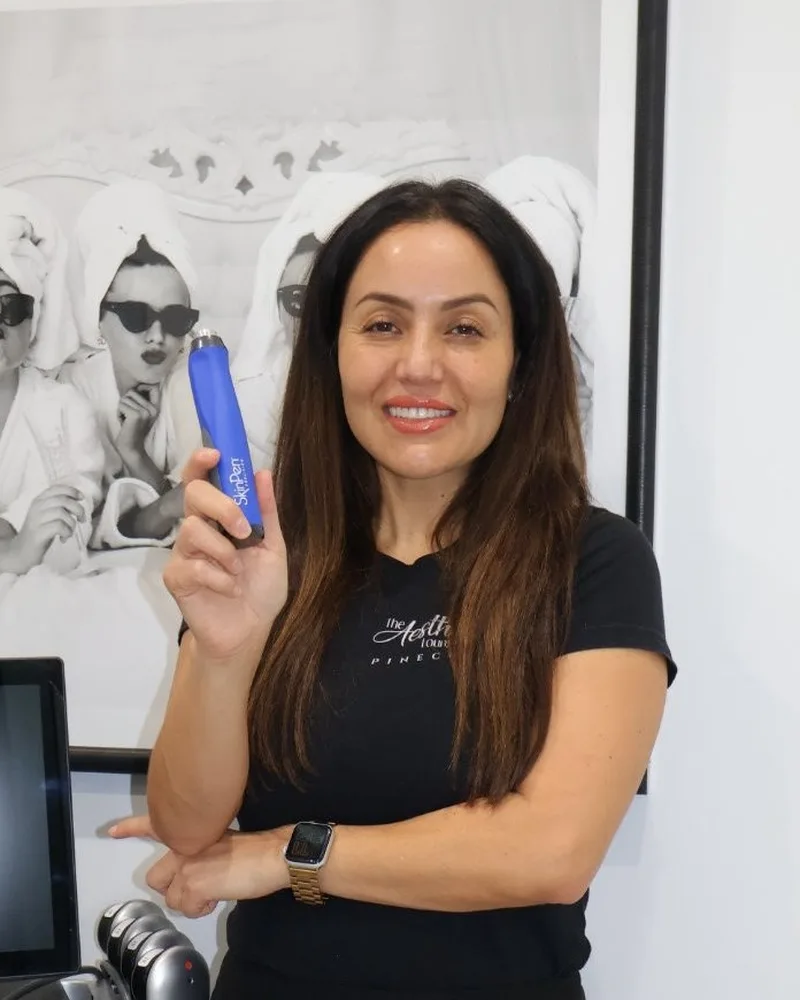 Faby Carr holding the SkinPen Precision device at AWE