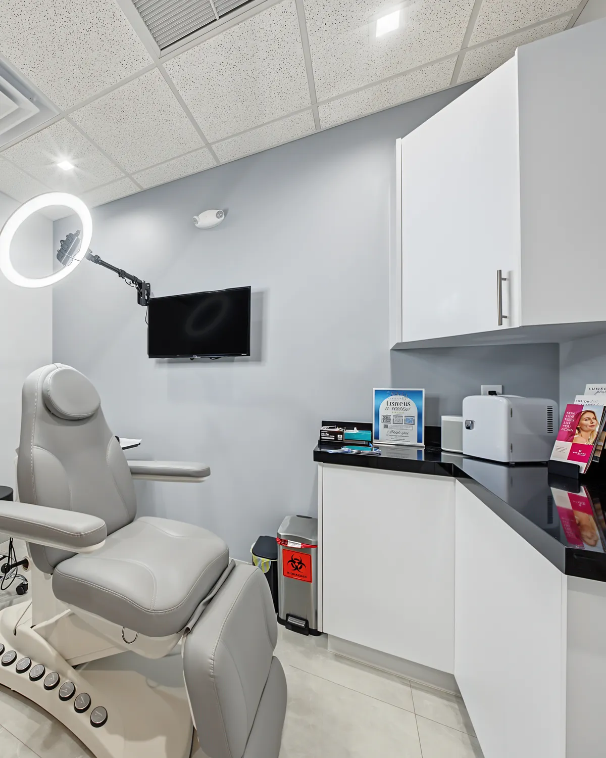 A treatment room at AWE with a reclining chair and a ring light